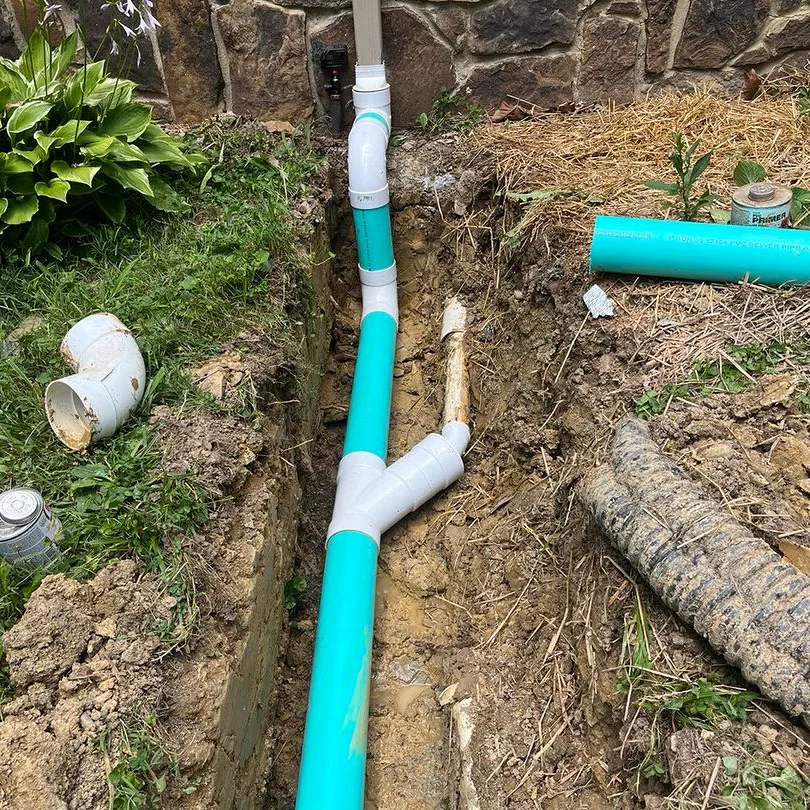 New underground plumbing pipe installed in an open trench